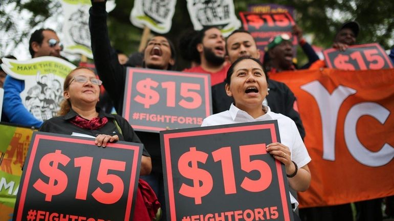 Veronica Ramos of Uniondale, right, a McDonald's manager, rallies with...