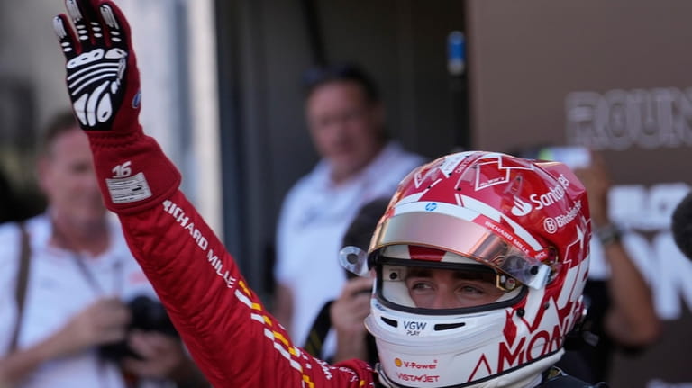 Ferrari driver Charles Leclerc of Monaco celebrates his pole position...