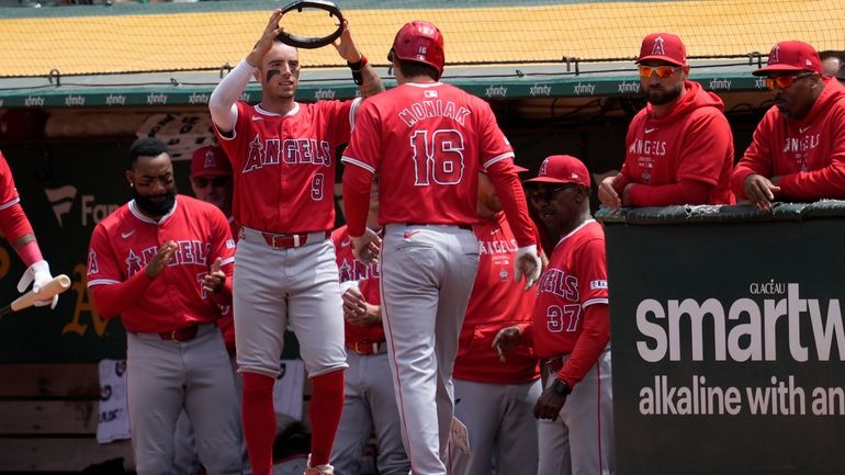 Los Angeles Angels' Mickey Moniak (16) is congratulated by Zach...