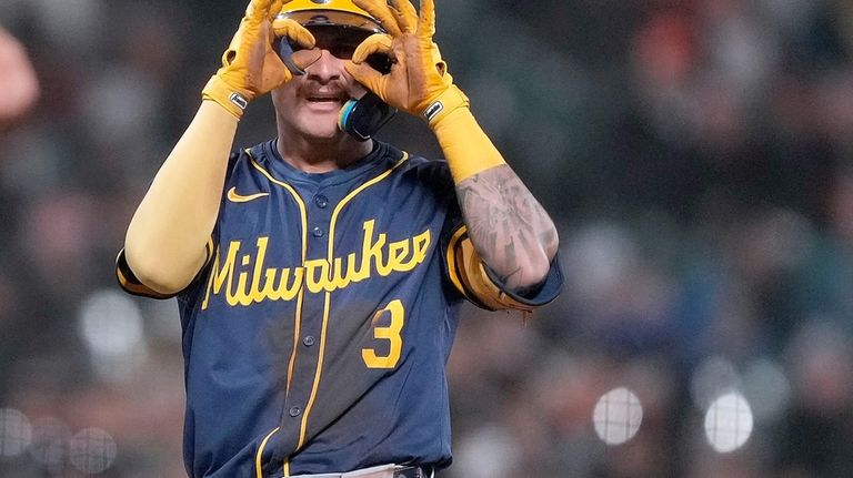 Milwaukee Brewers' Joey Ortiz gestures after hitting a triple against...