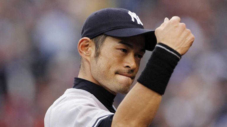 Ichiro Suzuki heads into the dugout after catching a fly...