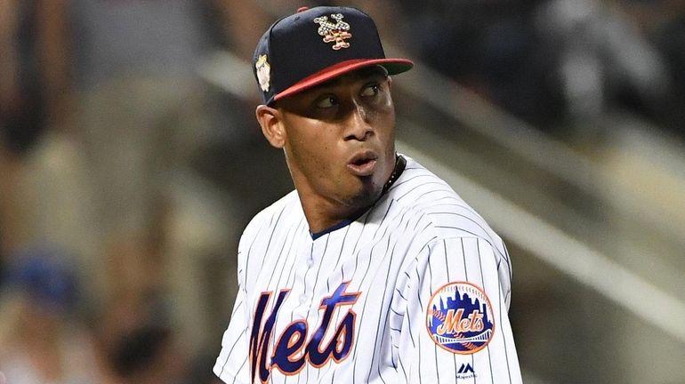 Mets relief pitcher Edwin Diaz reacts during the ninth inning...