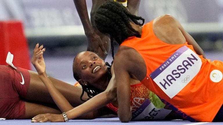 Silver medalist Sifan Hassan, of the Netherlands, congratulates gold medalist...