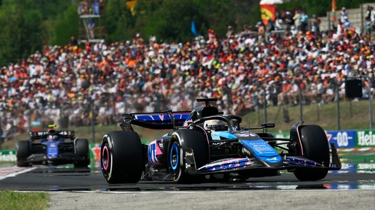 Alpine driver Esteban Ocon of France steers his car after...