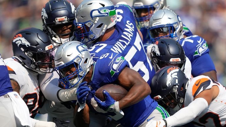 Seattle Seahawks running back Kenneth Walker III (9) is tackled...