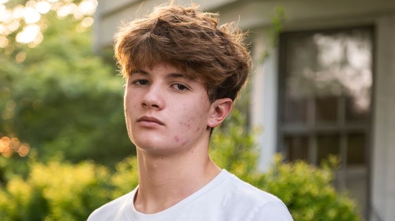 Chris Stanislawski, 14, poses for a portrait outside of his...