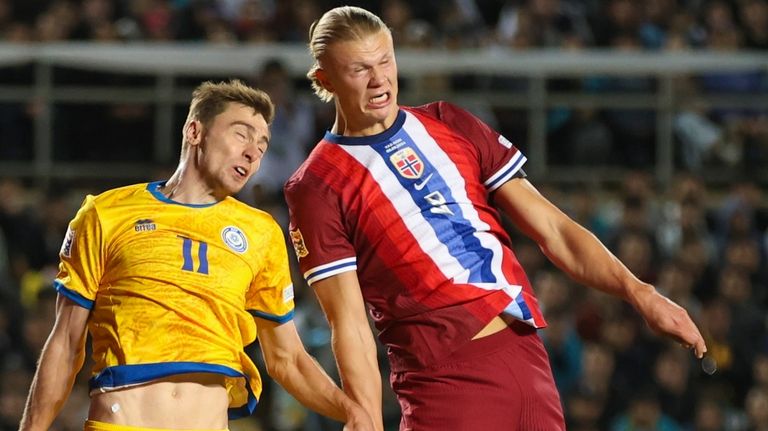 Kazakhstan's Yan Vorogovskiy, left, fights for the ball with Norway's...