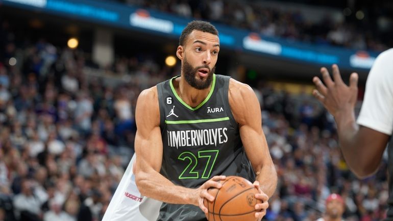 Minnesota Timberwolves center Rudy Gobert controls the ball in the...