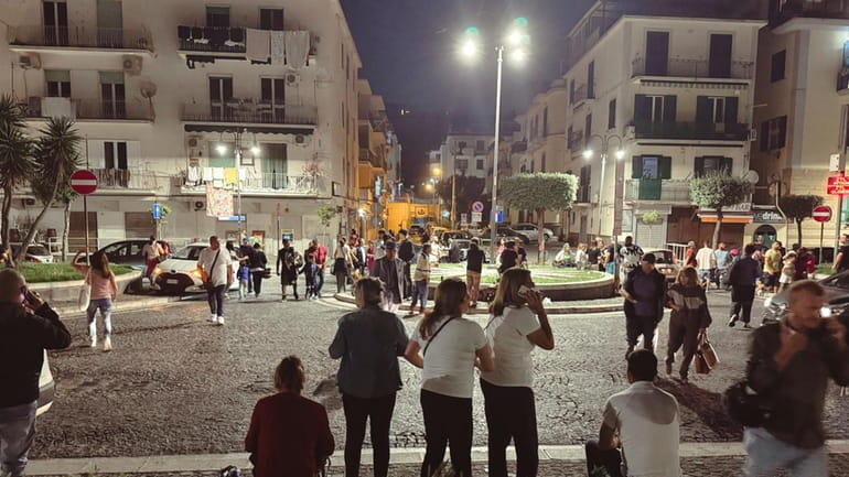 People gather in a street after an earthquake in Campi...