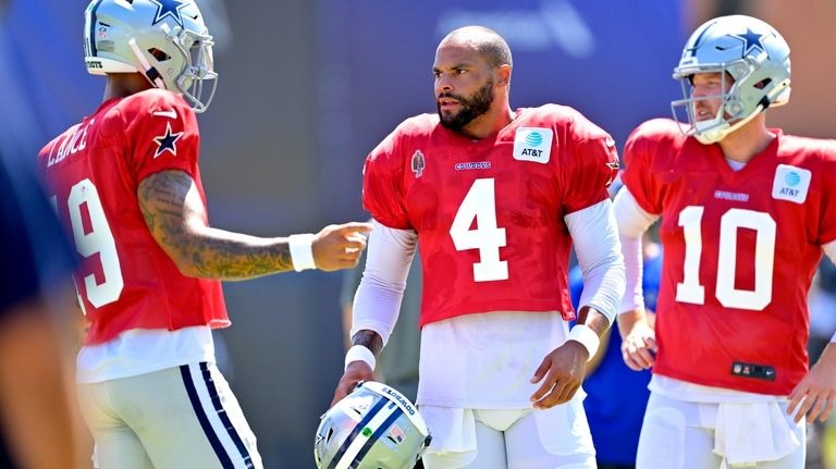 Dallas Cowboys quarterbacks Trey Lance, left, Dak Prescott and Cooper...