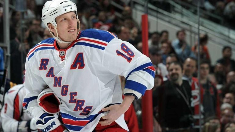 Marc Staal #18 of the New York Rangers looks on...