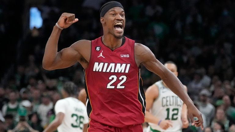 Miami Heat forward Jimmy Butler (22) reacts after scoring against...