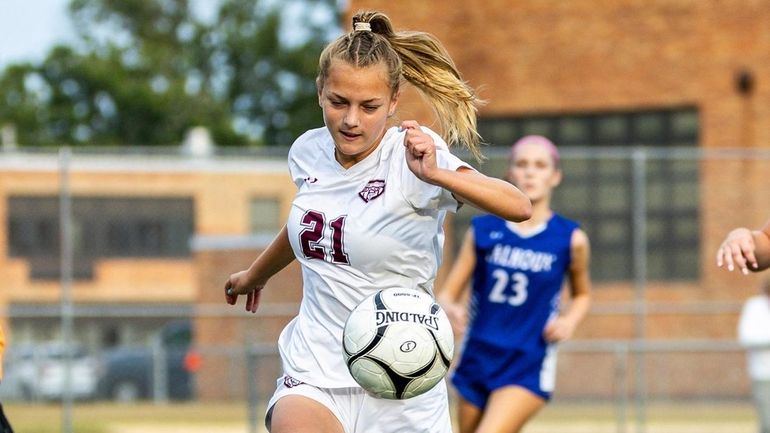 Chloe Benik of Garden City keeps the ball in play...