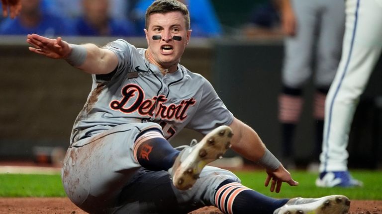 Detroit Tigers' Jace Jung slides home to score on a...