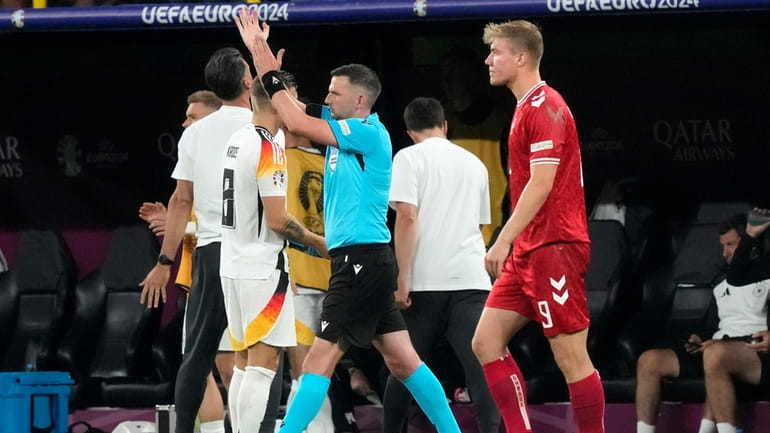 English referee Michael Oliver gives a penalty for handball against...