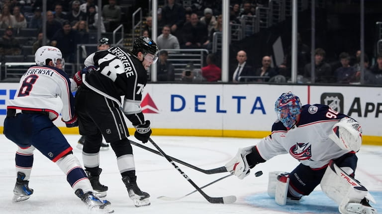 Los Angeles Kings right wing Alex Laferriere, second from left,...