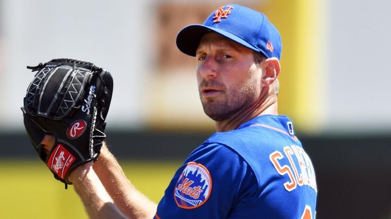 Max Scherzer of the Mets warms up before a spring training...