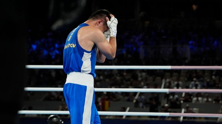 Uzbekistan's Hasanboy Dusmatov reacts after defeating France's Billal Bennama in...