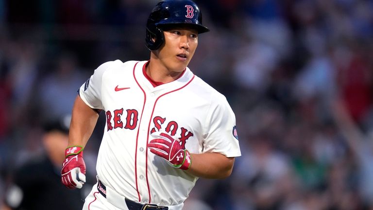 Boston Red Sox's Masataka Yoshida watches the flight of his...