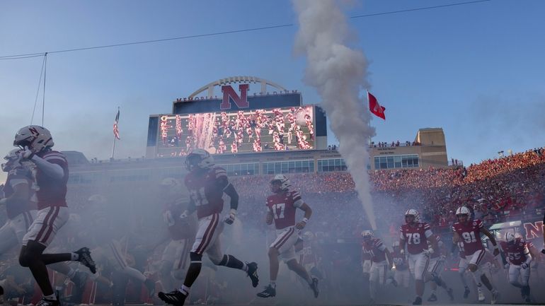 Nebraska players run onto the field before playing Northern Iowa...