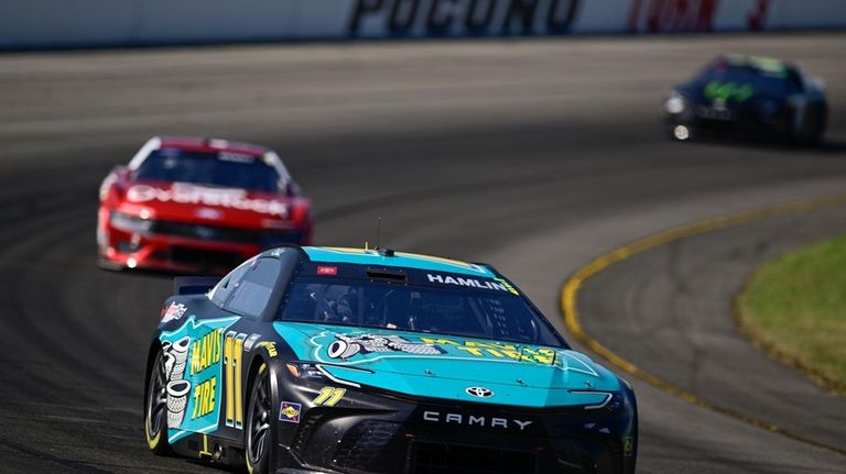 Denny Hamlin drives through Turn 3 during a NASCAR Cup...