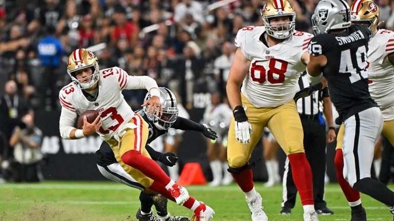 San Francisco 49ers quarterback Brock Purdy (13) runs with the...