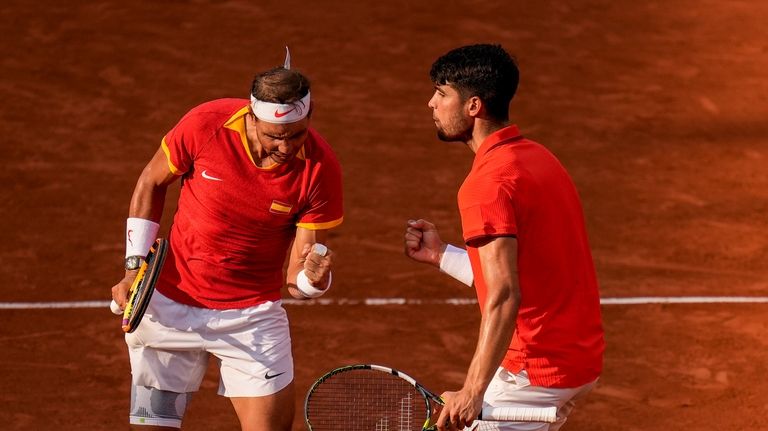 Carlos Alcaraz, right, and Rafael Nadal of Spain celebrate a...