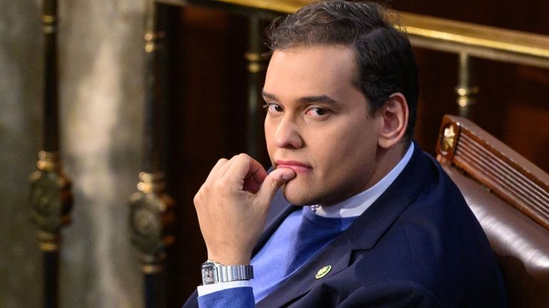 Rep. George Santos looks on as the House convenes on Jan....