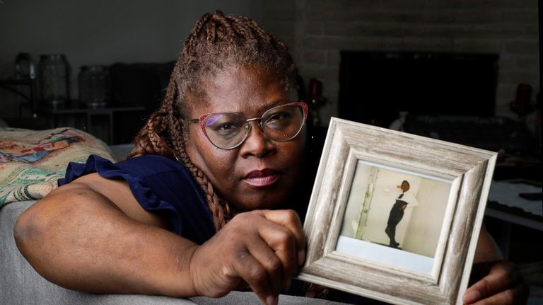 Janet Jarrett holds a photograph of her, Pamela Jarrett, at...