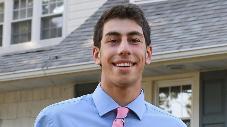 Massapequa's Nicholas Bianco holds his Special Achievement Award for excellence on...