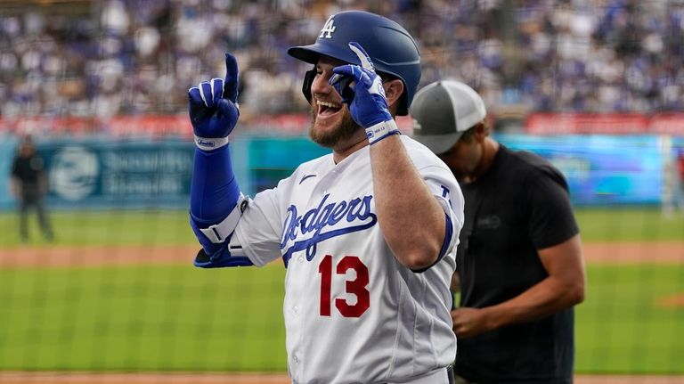 Los Angeles Dodgers' Max Muncy (13) celebrates after hitting a...