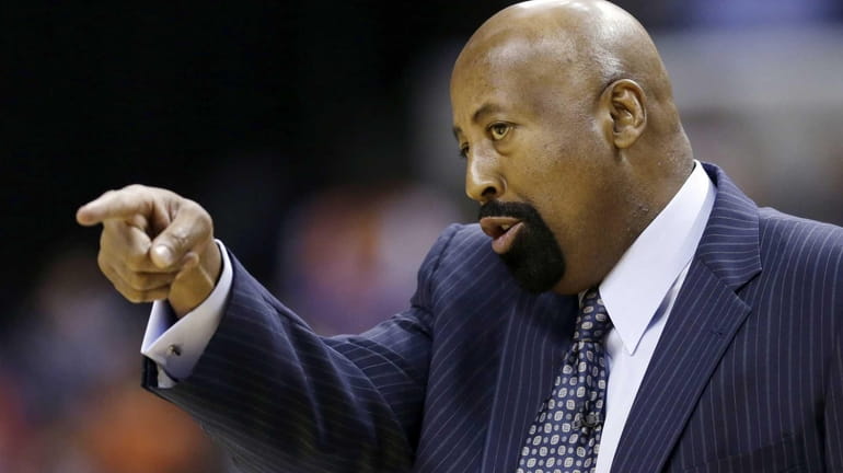 Mike Woodson gives directions to his team during the first...