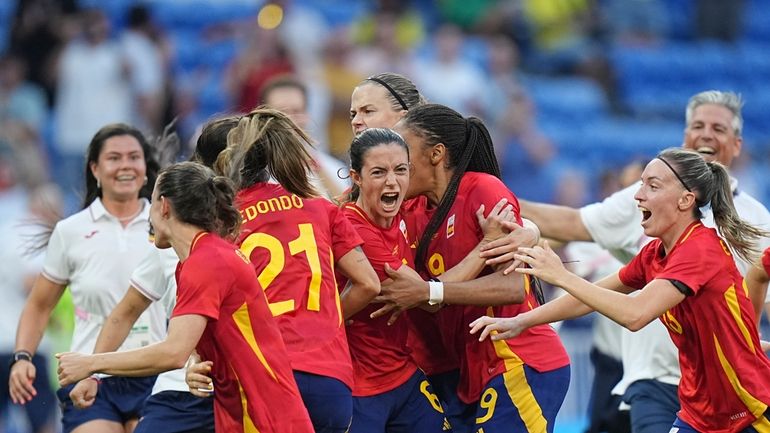 Players of Spain celebrate after defeating Colombia in a penalty...