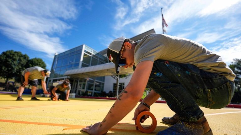 Ronnie Jefferies works on the parking lot at Science, Arts...