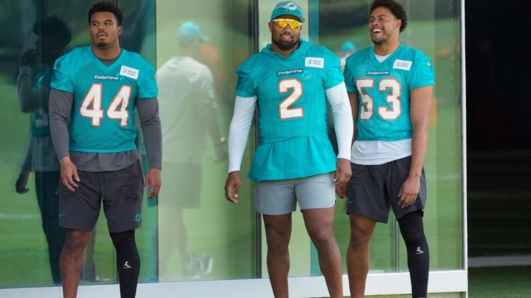 Miami Dolphins linebackers Chop Robinson (44) Bradley Chubb (2) and...