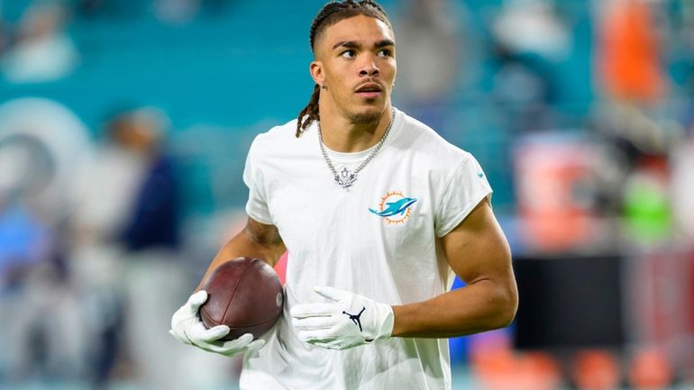 Miami Dolphins wide receiver Chase Claypool (83) warms up on...