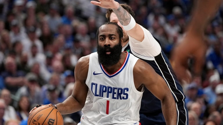 Los Angeles Clippers guard James Harden (1) drives past Dallas...