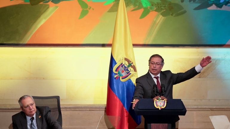 Colombian President Gustavo Petro delivers a speech next to outgoing...