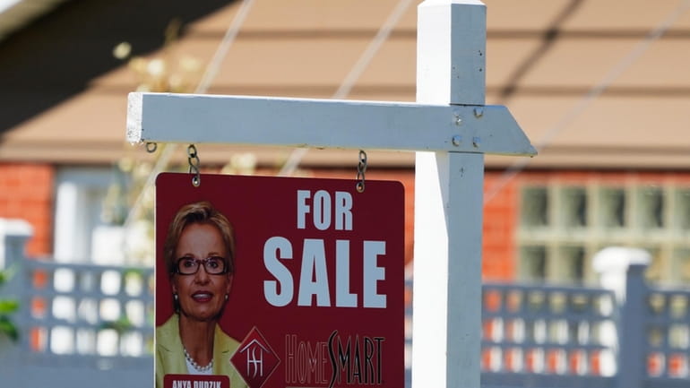 A for sale sign stands outside a residence in Niles,...
