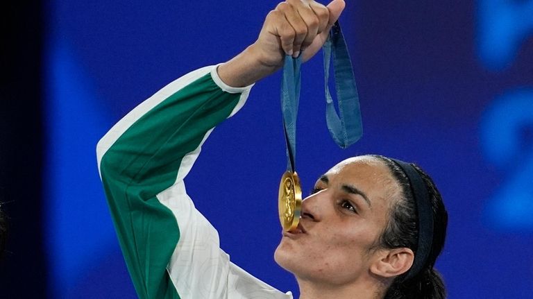 Gold medalist Algeria's Imane Khelif kisses her medal for the...