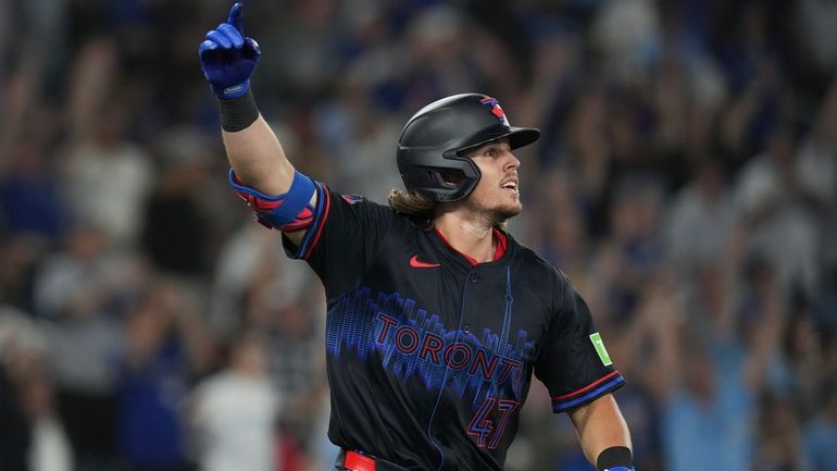 Toronto Blue Jays' Addison Barger celebrates after hitting a walkoff...