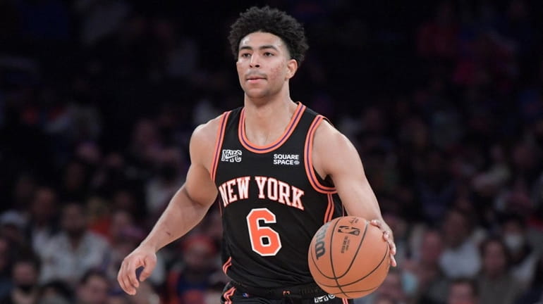 Quentin Grimes of the Knicks dribbles the ball against the Hawks...