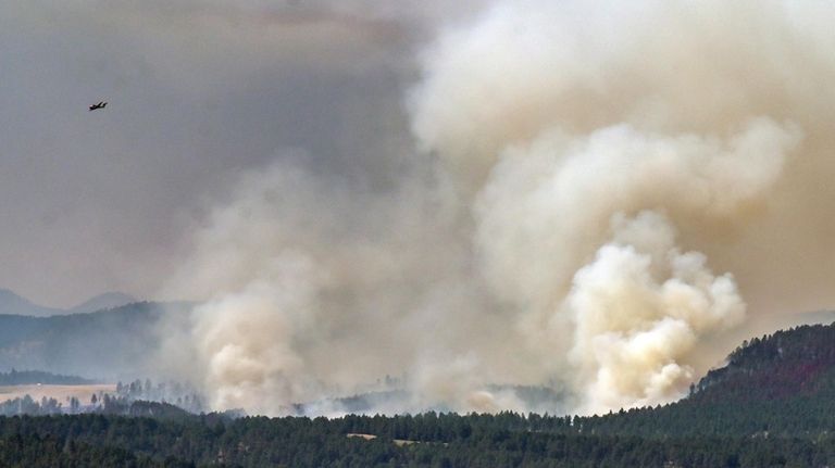 Smoke billows from the First Thunder Fire, Tuesday, Sept. 3,...