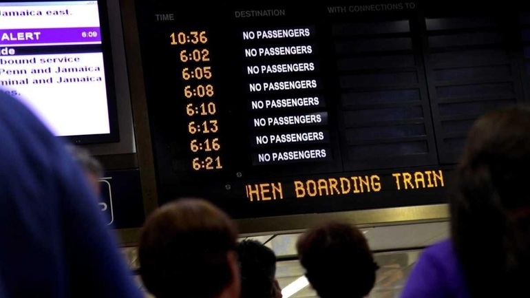 Passengers wait at Penn Station after a lightning strike hit...