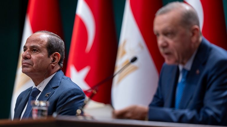 Egyptian President Abdel Fattah el-Sissi, left, listens to Turkish President...