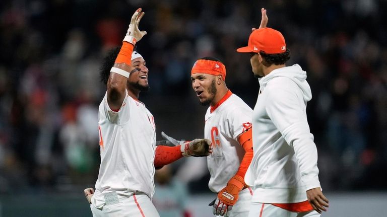 San Francisco Giants' Luis Matos, left, celebrates with teammates after...