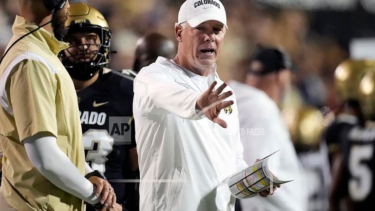 Then Colorado quality control analyst Pat Shurmur, right, gestures in...