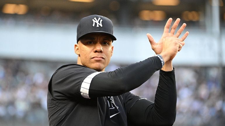 Yankees’ Juan Soto looks on from the dugout during an...