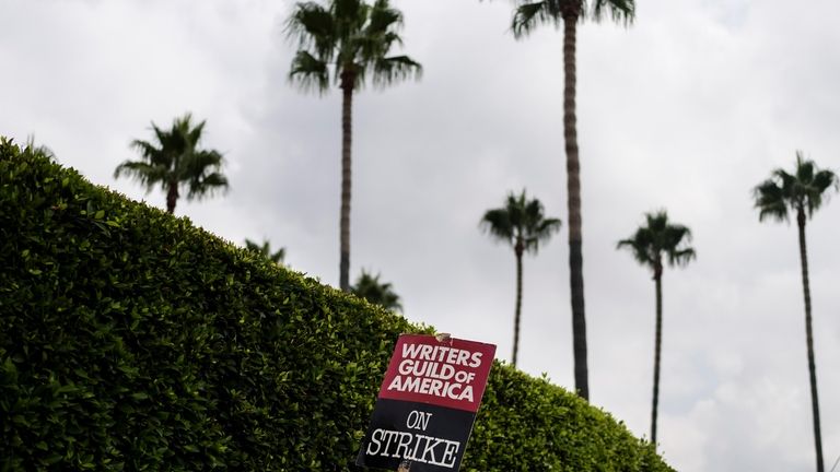 A demonstrator holds up a sign during a rally outside...