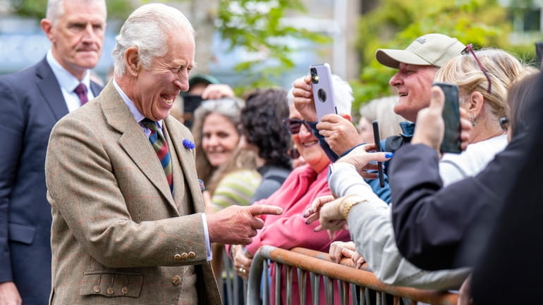 Britain's King Charles III meets members of the public during...